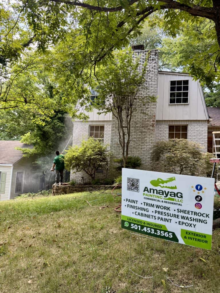 Pressure washing the exterior of a home before repainting